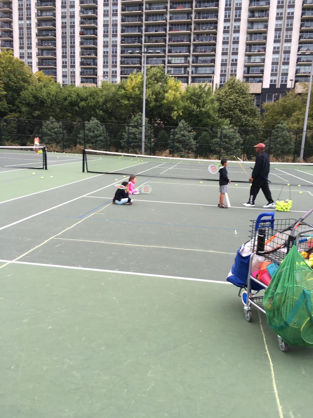 Coach Jay Campbell working with young players on a city court